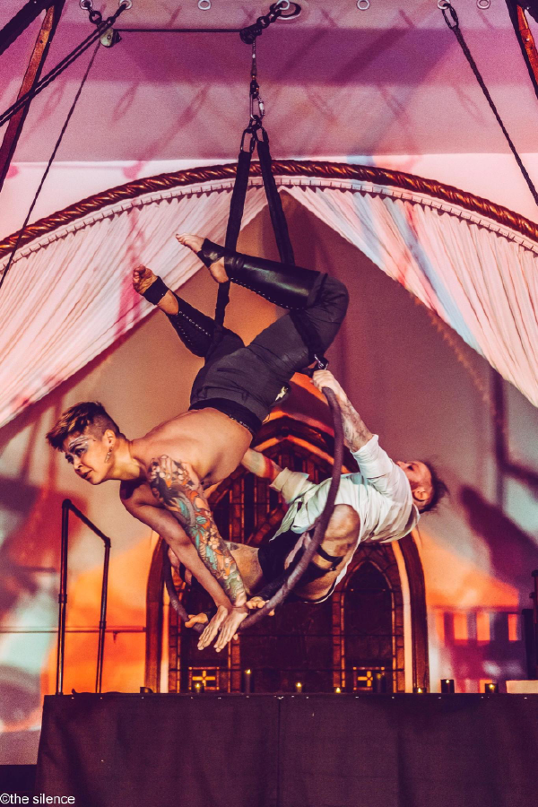 "dearly undeparted", duo aerial hoop act in the "weddings and funerals" twisted windows show