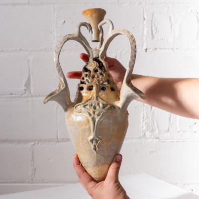 &ldquo;held earthenware vase&rdquo;